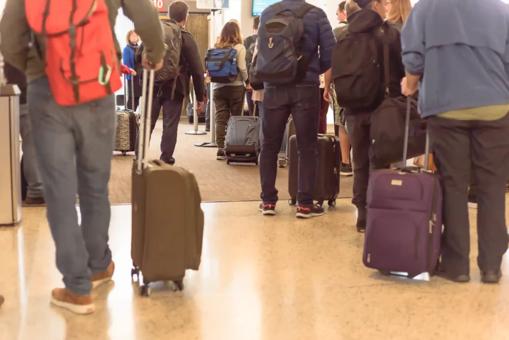 Hundreds of People waiting in airport lines